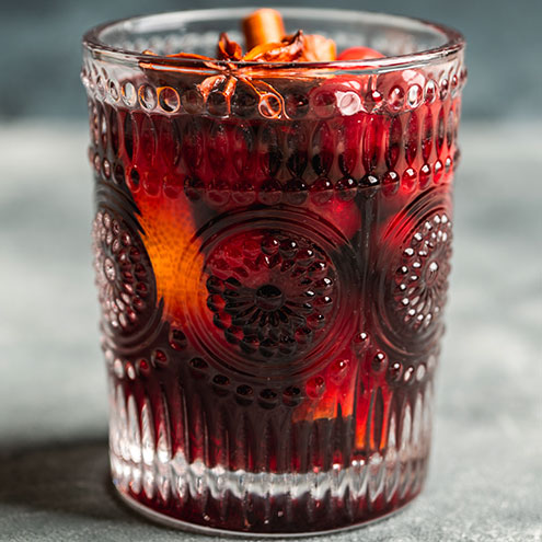 Glass of mulled wine with cinnamon and star anise garnish
