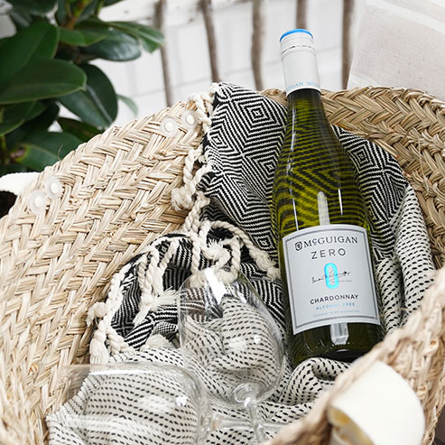 McGuigan Zero Chardonnay in a picnic basket with a black and white blanket