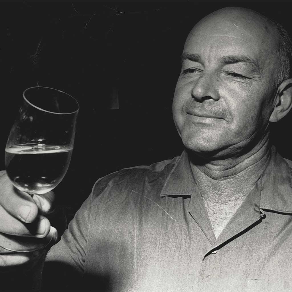 McGuigan winemaker holding a glass of wine