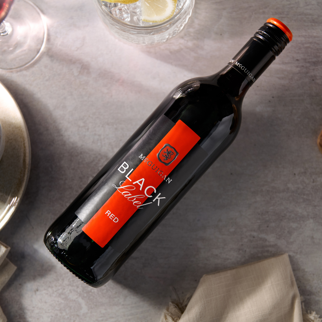 McGuigan winemaker holding a glass of wine