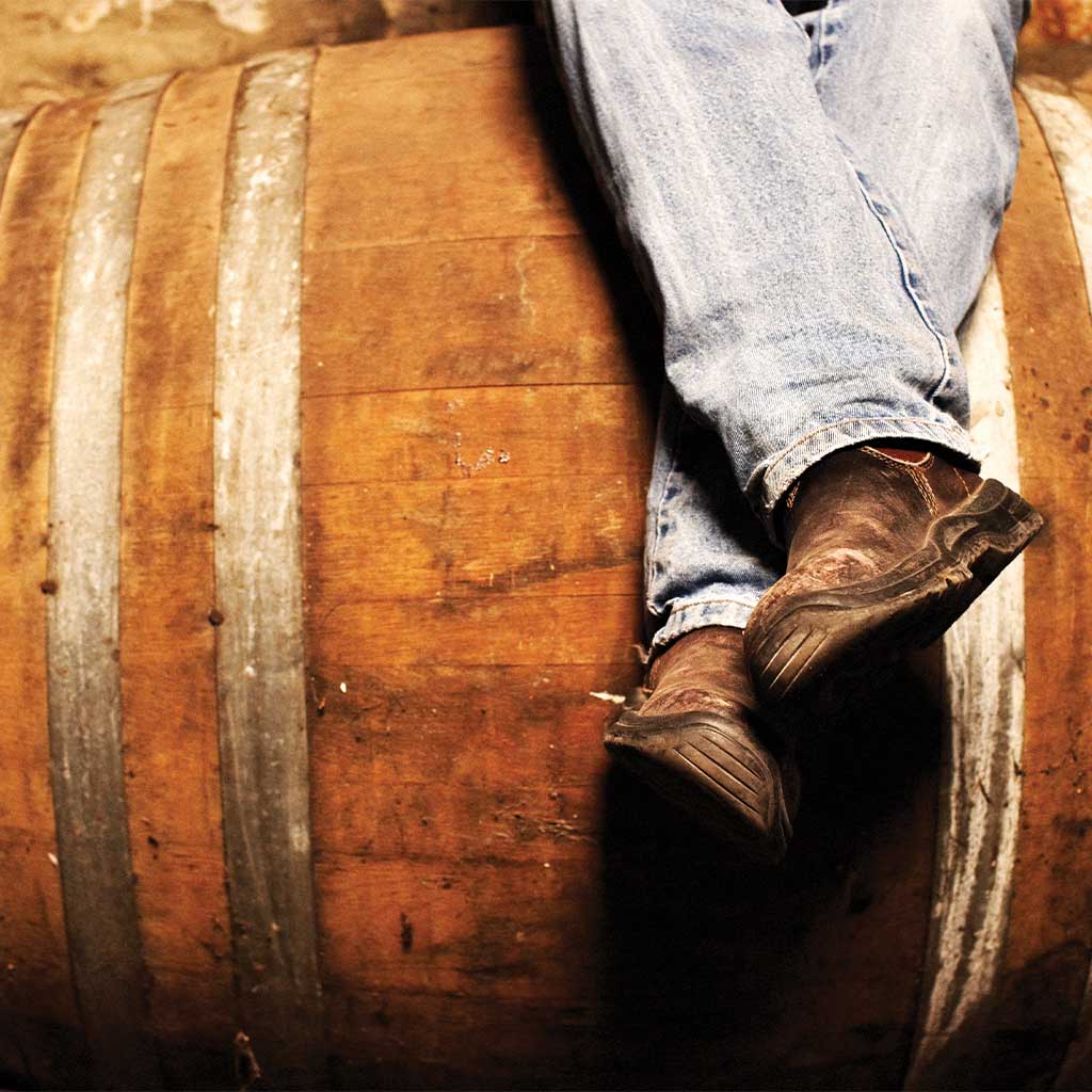 person sitting on a wine barrel