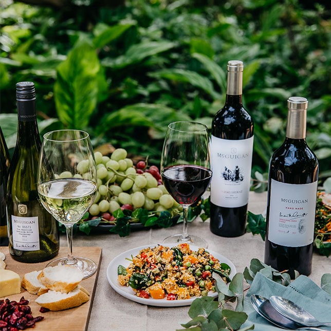 McGuigan Alcohol Varietals outdoors with fruit and crackers