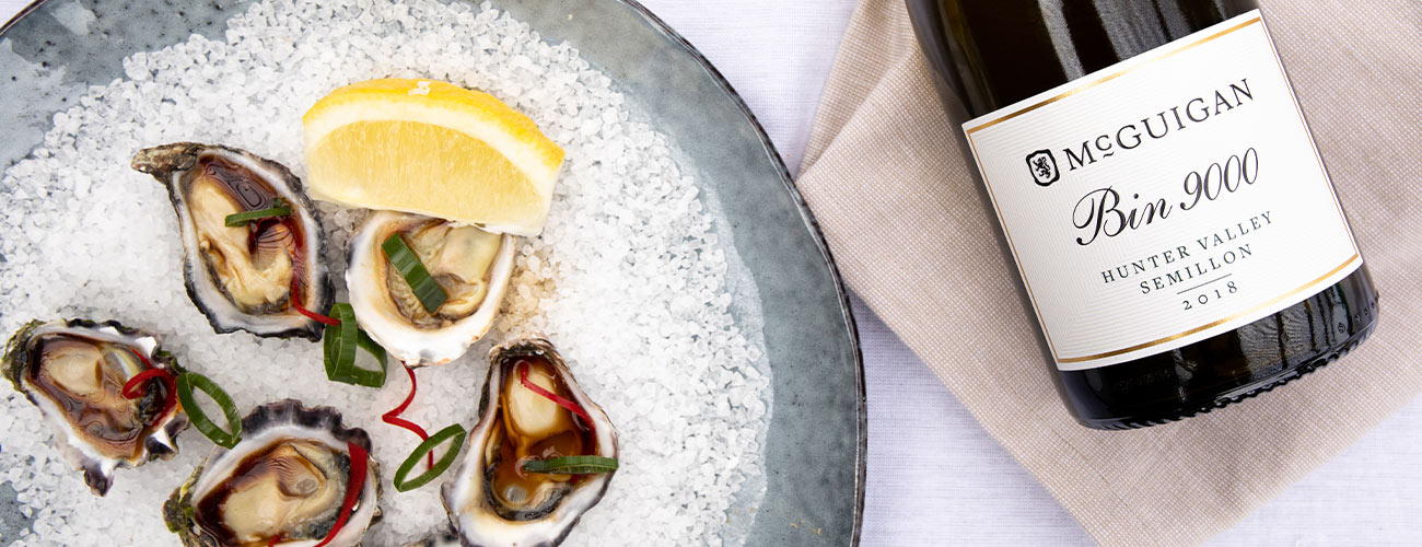 White wine on table with oysters