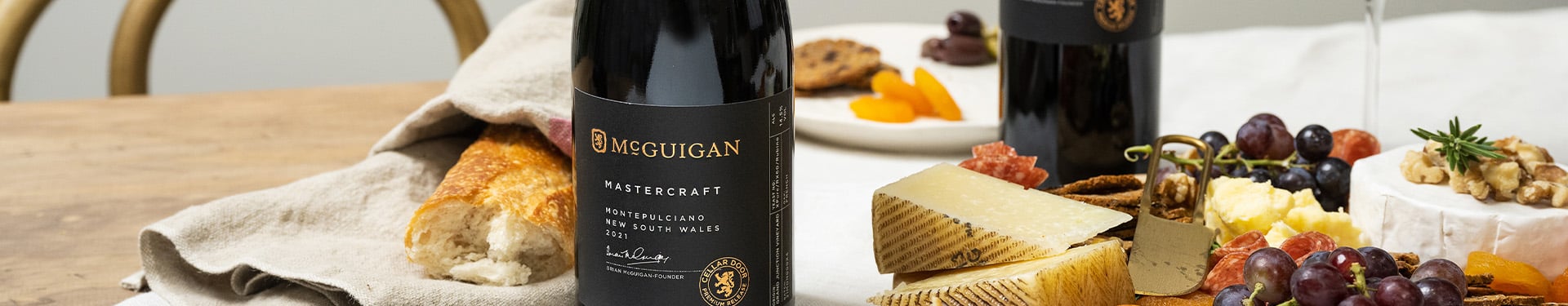 Bottle of McGuigan Mastercraft varietal next to bread and fruit